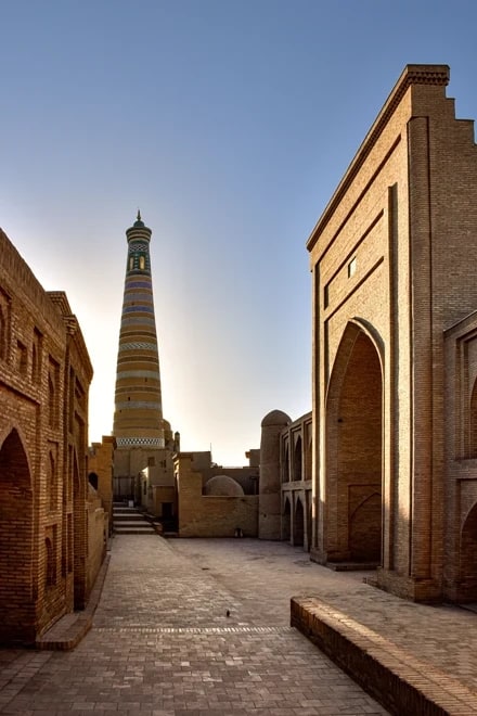 A covered bazaar arcade hung with suzani and ikat textiles