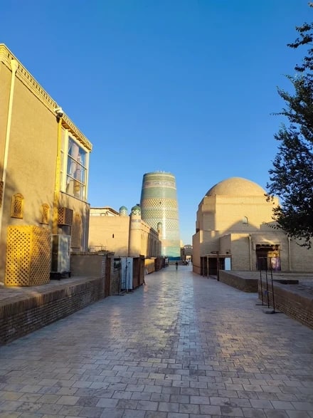 An empty paved street leading to the Kalta Minor at golden hour