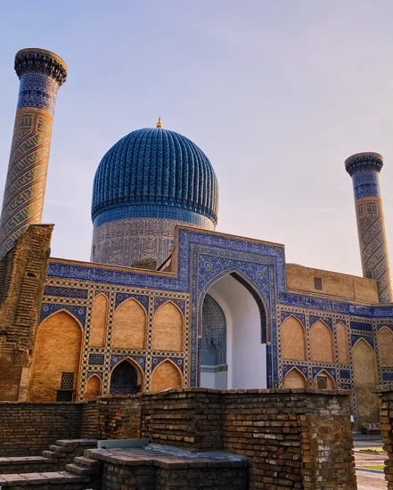 The Gur-e-Amir mausoleum's fluted blue dome at golden hour