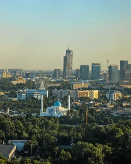 Tashkent's modern skyline rising behind a blue-domed mosque