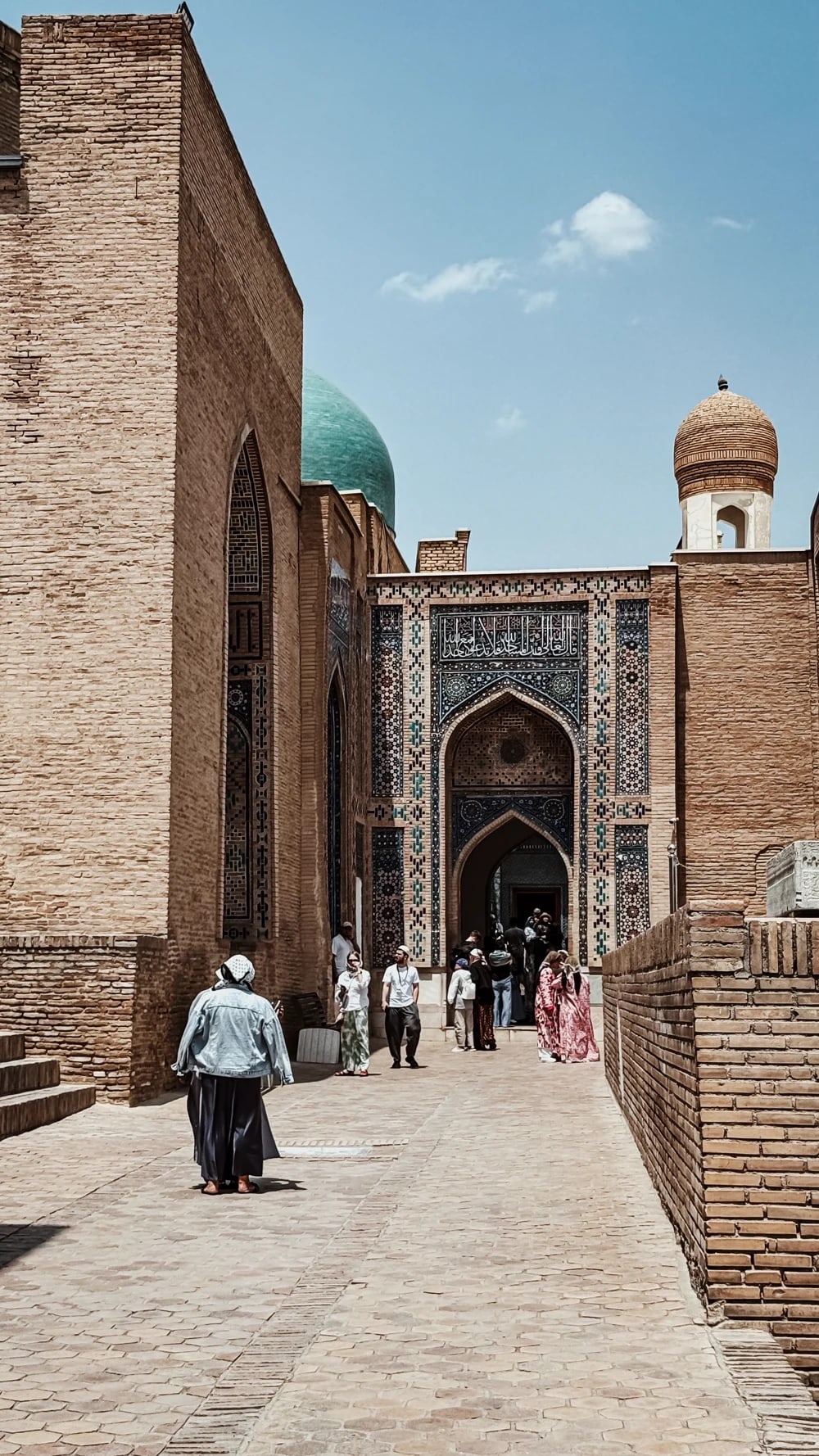 Visitors in traditional dress at the Shah-i-Zinda entrance portal in Samarkand